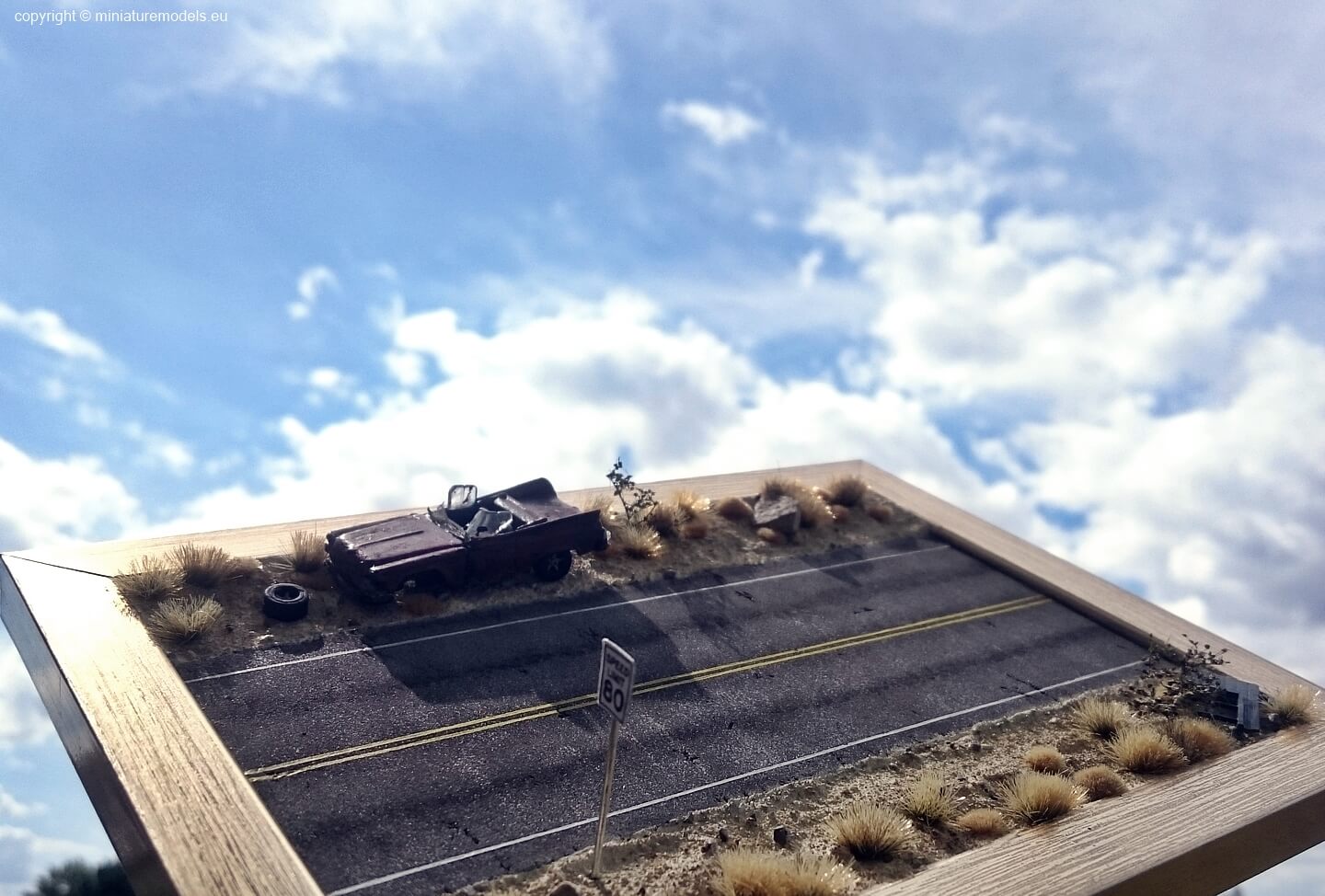 Diorama of american road with clouds in the background