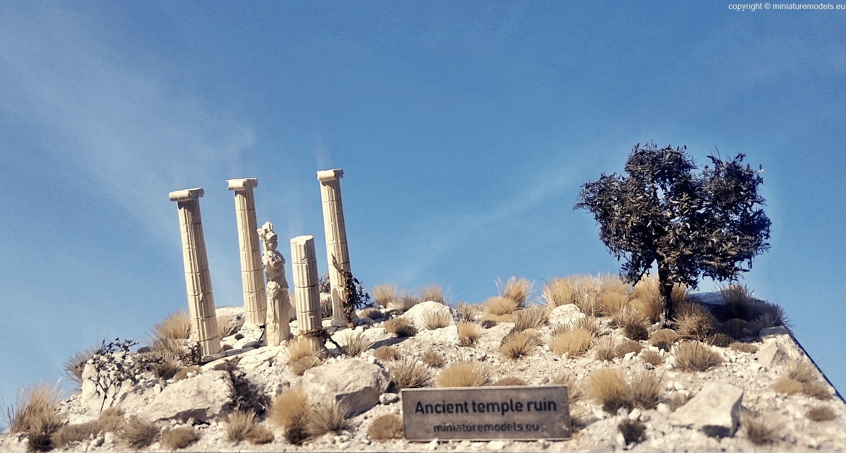 Miniature model of ancient temple ruin with sky and sun
