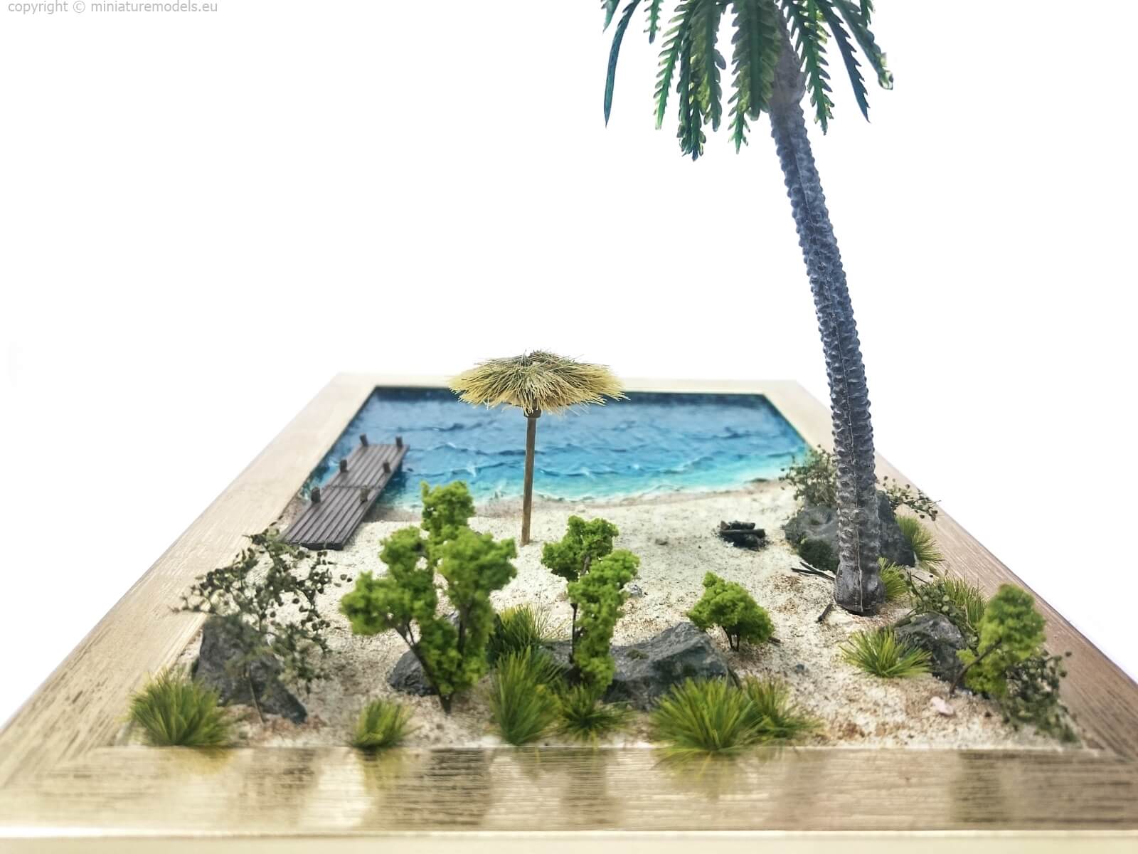 Diorama containing beach, flora and sea