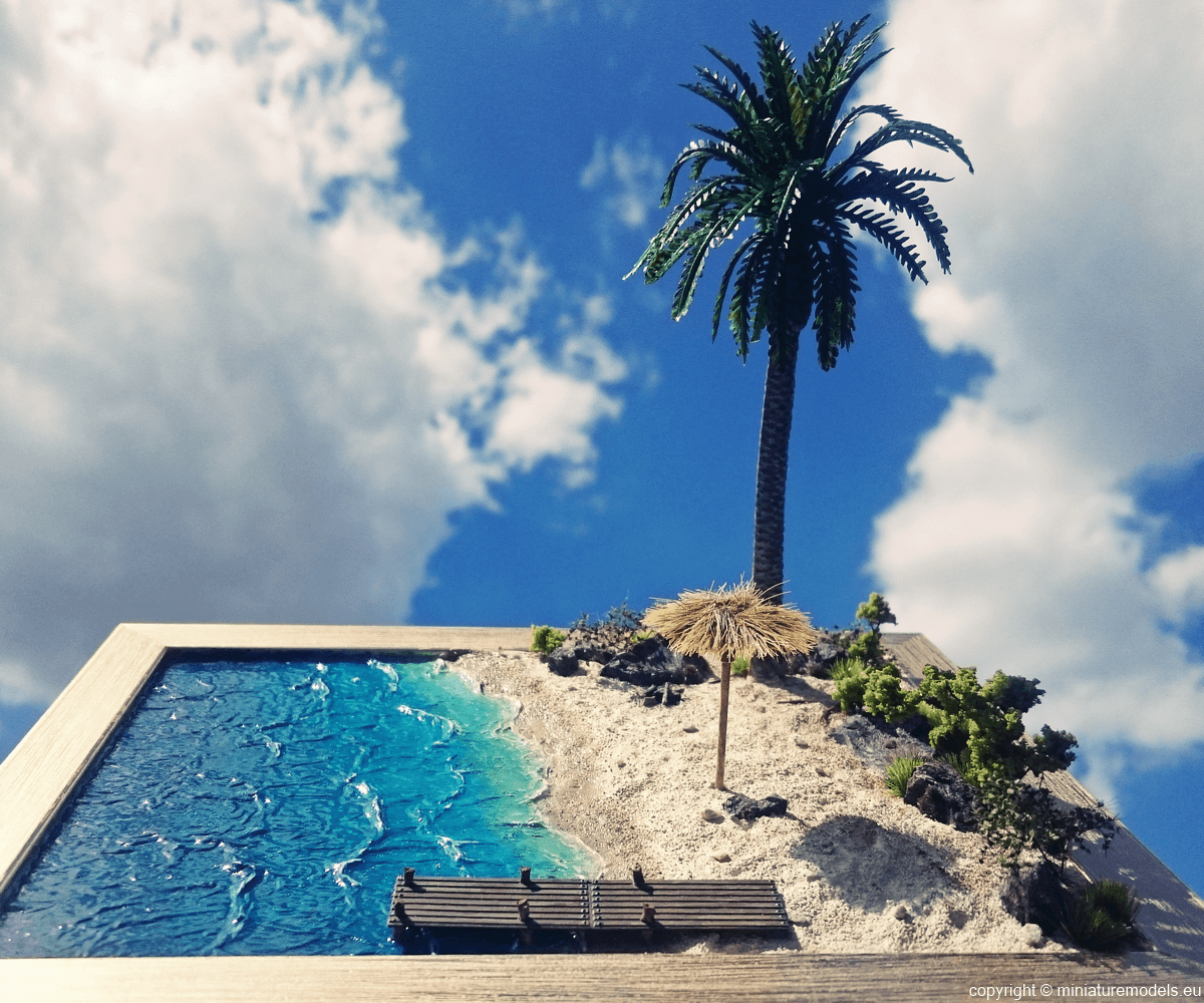Tropical beach diorama with blue sky and clouds